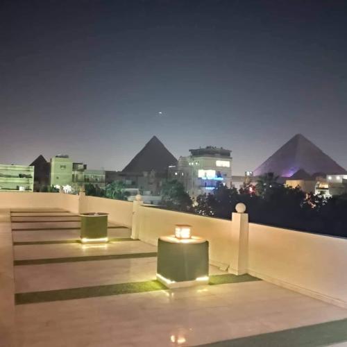 a view of the pyramids from a rooftop at night at Matto Pyramids Inn in Cairo