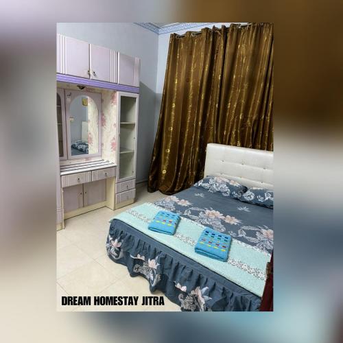 a bedroom with a bed with a dresser and a mirror at Homestay Jitra Dream Homestay in Jitra