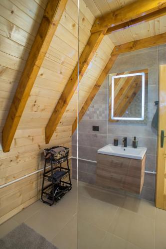 a bathroom with a sink in a attic at Mountain inn in Žabljak