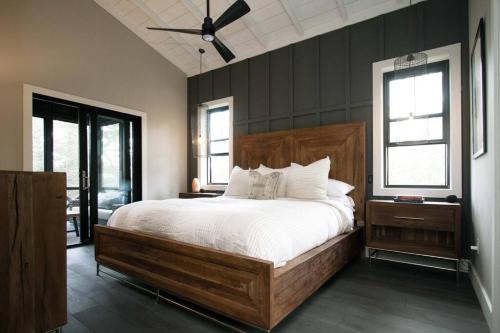 a bedroom with a large bed and a ceiling fan at NEW Rustic Modern Cabin at Lutsen Mountains in Lutsen