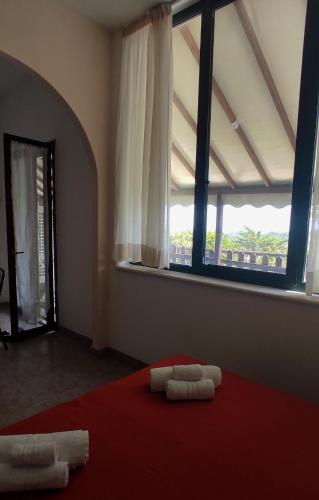 two towels on a bed in a room with a window at Il Corbezzolo in Ripatransone