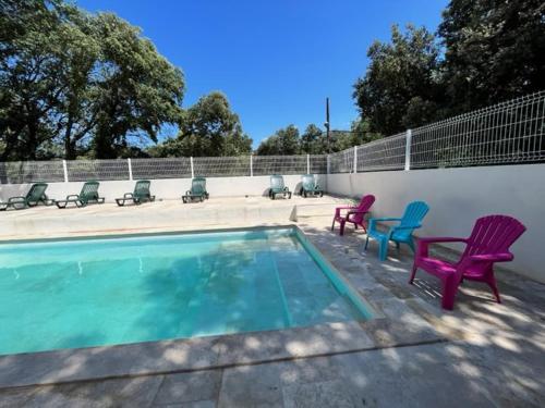 a swimming pool with lawn chairs at Domaine du Bérange in Saint-Geniès-des-Mourgues