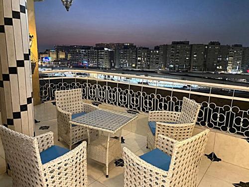 a table and chairs on a balcony with a view at LuXury Apartment Nasr City - CityStars in Cairo