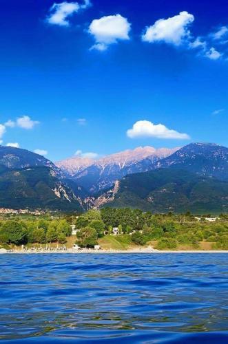 a large body of water with mountains in the background at Nemesis in Litochoro