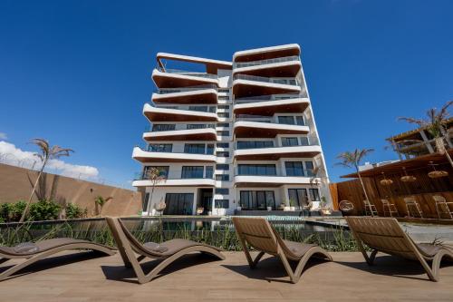 a large apartment building with two chairs in front of it at Résidence Théa in Dakar