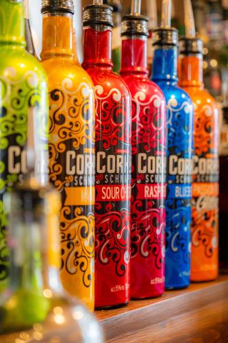 a group of bottles of soda sitting on a shelf at The George Hotel in Axminster