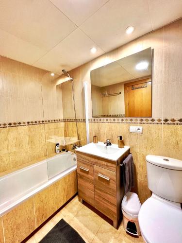 a bathroom with a sink and a toilet and a tub at BORA BORA Ático con piscina privada en Vera Paraíso in Vera