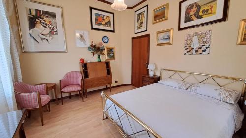 a bedroom with a bed and a table and chairs at Villa Tessa in Ronciglione