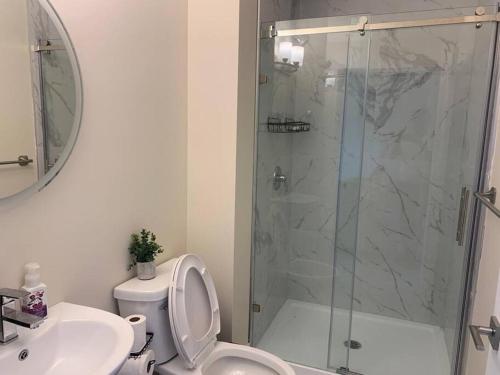 a bathroom with a shower and a toilet and a sink at 1 bedroom apartment in Halifax