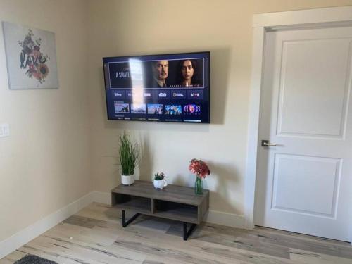 a living room with a flat screen tv on the wall at 1 bedroom apartment in Halifax