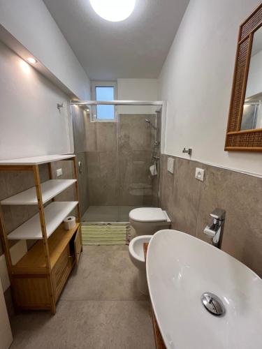 a bathroom with a shower and a toilet and a sink at Villetta Santa Maria in Leuca