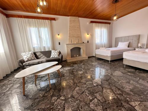 a living room with a bed and a fireplace at Magdalini House in Paralion astros