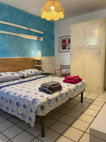 a bedroom with a bed and a chandelier at Villetta Santa Maria in Leuca