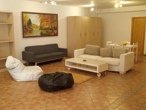 a living room with two couches and a table at Estancia en plena naturaleza-Andrea in Sotogrande
