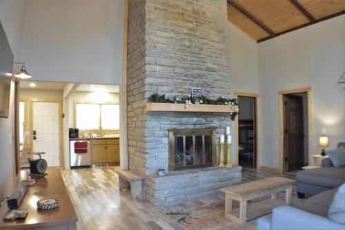 a living room with a stone fireplace in a house at Cozy cabin with boosted Wi-Fi in Beech Mountain