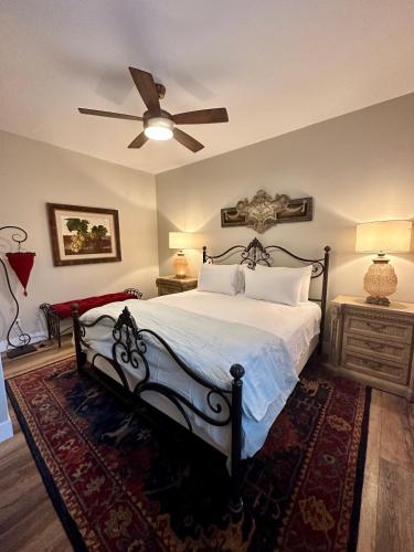 a bedroom with a bed and a ceiling fan at Bisbee Brownstone Suites in Bisbee