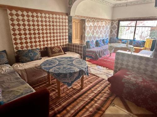 a living room with a couch and a table at Maison D'hote Chez La Famille in Tamellalt