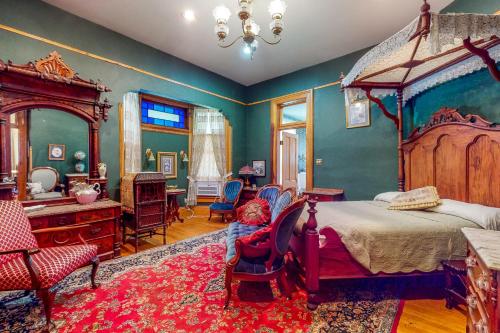 a bedroom with a bed and a desk and chairs at Clarkson W Freeman House in Springfield