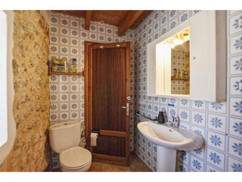 a bathroom with a toilet and a sink at Country house with panoramic views and small pool in Inca in Inca