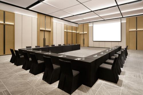 a conference room with a large table and chairs at Courtyard by Marriott Sejong in Sejong