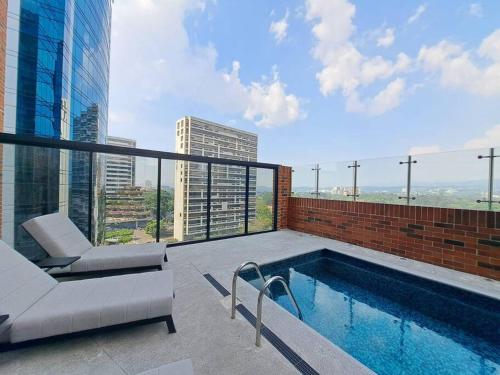a swimming pool on the roof of a building at Luxury Apartment in zone 10 in Guatemala