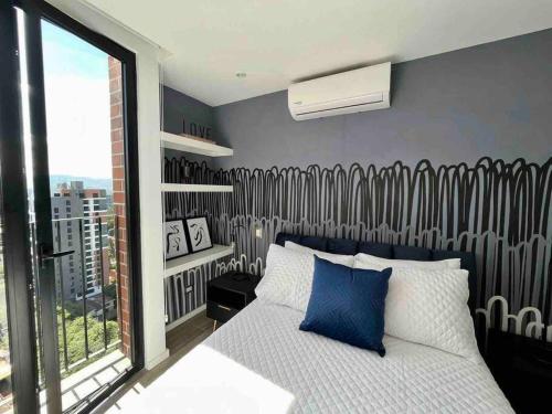 a bedroom with a bed and a large window at Luxury Apartment in zone 10 in Guatemala