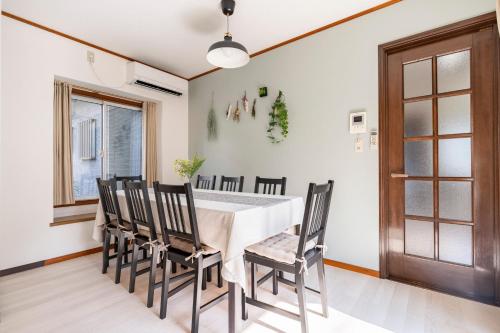 a dining room with a white table and chairs at BISK PARK TOKYO - 4LDK&2Bath Spacious House - Easy Access to Asakusa, Skytree & Airport in Tokyo