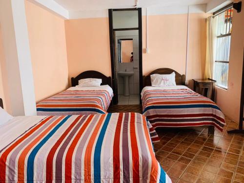 Cama o camas de una habitación en Fidelísima Hotel