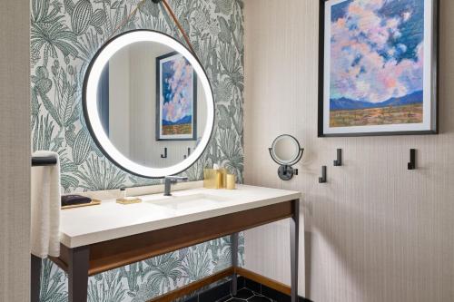 a bathroom with a sink and a mirror at The Leo Kent Hotel, Tucson, a Tribute Portfolio Hotel in Tucson