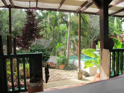 a view of a garden with a swimming pool at Villa in Aruba's nature's paradise in Santa Cruz