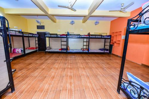 a room with four bunk beds and a wooden floor at HARIYALI RESORT in Sardārgarh