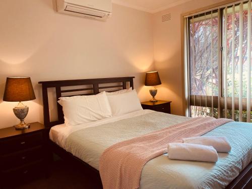 a bedroom with a bed with two pillows on it at Intrigue FREE WI-FI in Apollo Bay