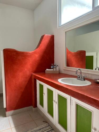 een badkamer met een wastafel en een spiegel bij Casa Faro in Troncones