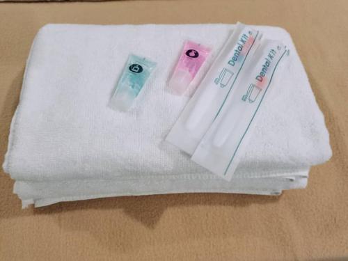 three toothbrushes sitting on a towel on a table at Shangg INN in Ipoh