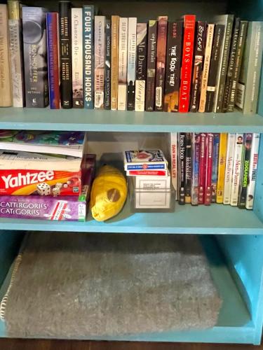 a book shelf filled with lots of books at Kataluma Inn, Sandpoint, Idaho - Entire Cozy Cabin, Pet Friendly in Sandpoint