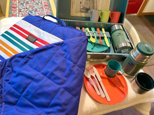 a table with a bag and a plate with utensils at Kataluma Inn, Sandpoint, Idaho - Entire Cozy Cabin, Pet Friendly in Sandpoint
