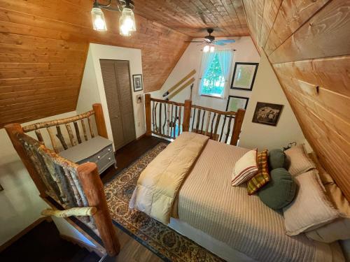 - une chambre avec un lit et une chaise dans l'établissement Kataluma Inn, Sandpoint, Idaho - entire cozy cabin, à Sandpoint