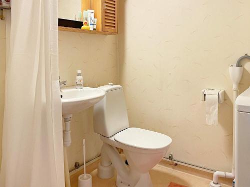 a bathroom with a toilet and a sink at Holiday home Lekeryd II in Lekeryd