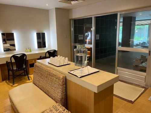 a room with a counter with a chair and a table at Spa and Esthetique Suichokan-Female&Adult Only in Jozankei