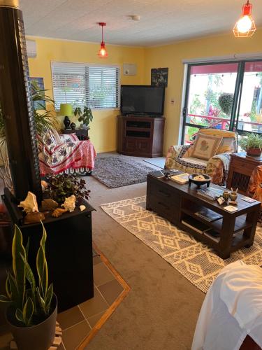 a living room with a couch and a coffee table at Karikari Lodge in Tokerau Beach