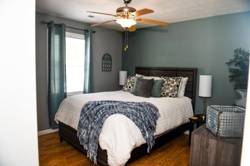 a bedroom with a bed and a ceiling fan at 5 Star with Direct Access to Brimstone Recreation Game Room Comfortable Up to 4 Bedrooms Stylish in Huntsville