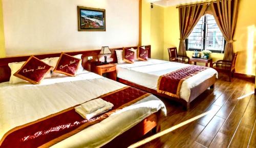 Postel nebo postele na pokoji v ubytování Cherry Hotel