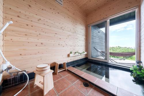 a wooden room with a bench and a window at The OCEAN VISTA in Shiraoi