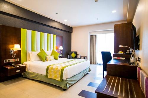 A bed or beds in a room at Platinum Grand