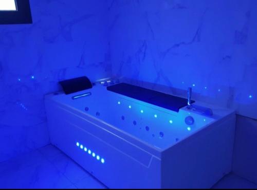 a bathroom with a tub with blue lights in it at Magnifique appart avec jaccuzi in Criel-sur-Mer