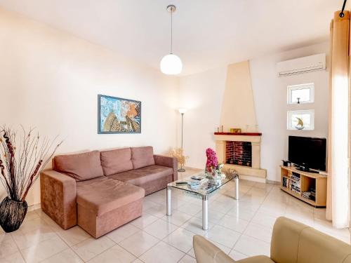 a living room with a couch and a fireplace at Luxury Villa in Kalamitsi Alexandrou in Kalamítsion Alexándrou