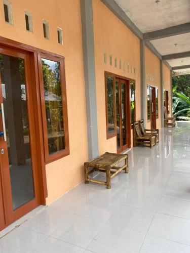 a hallway of a building with benches in it at Pondok Evsi in Senaru