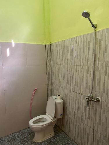 a bathroom with a toilet and a shower at Pondok Evsi in Senaru