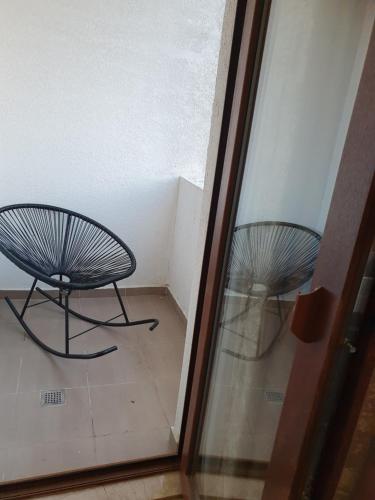 a glass door with a bench sitting in a room at The Fresh Wave hotel in Batumi