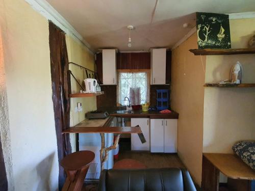 a small kitchen with a table and a counter top at Steve's cottage-homely in Nanyuki